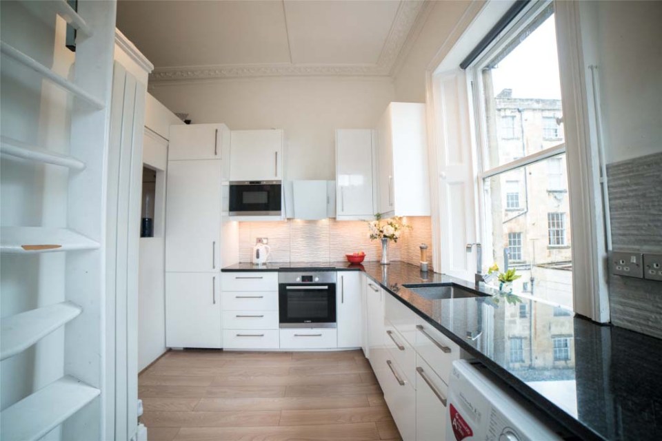 The spacious kitchen features modern wipe-clean surfaces and plenty of light