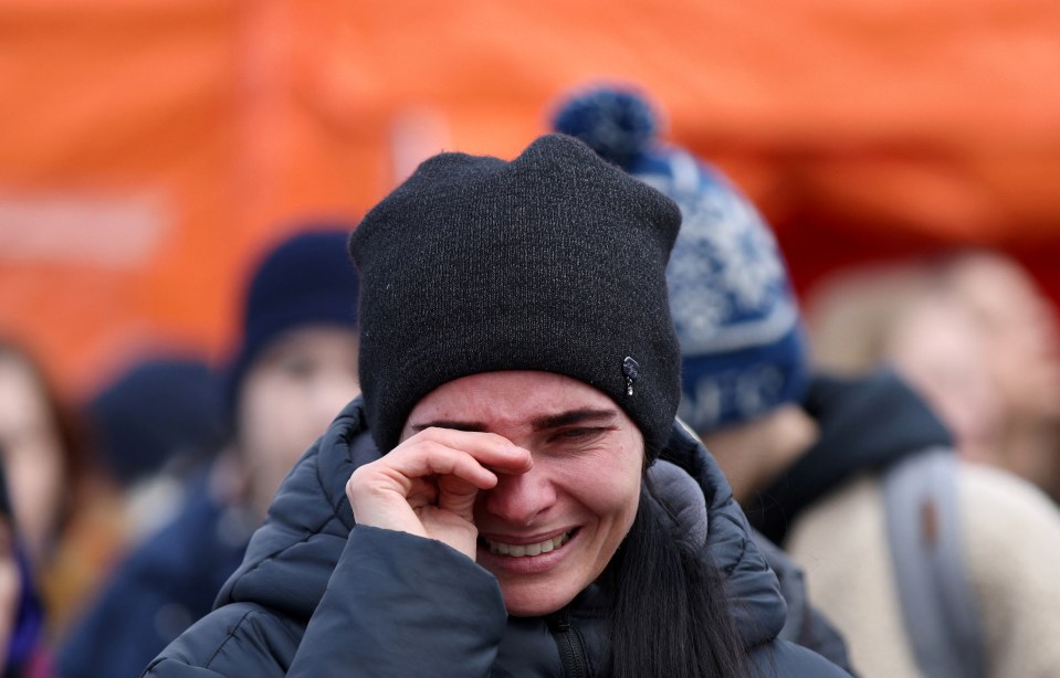 Ministers hope the Homes for Ukraine project will finally show the UK is stepping up to the plate - a woman cries after crossing the border into Poland