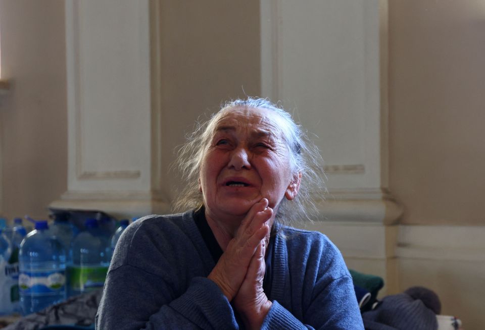 A Ukrainian woman cries after reaching safety and crossing the border into Poland