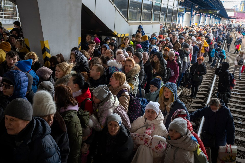 At Kyiv's train station, people crowd as they try to get on a train to Lviv