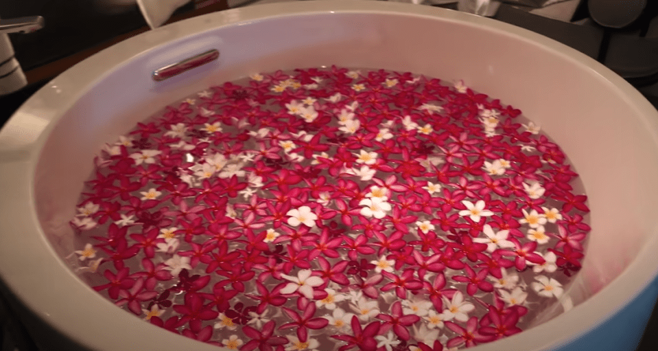 There's a huge bath filled with flower petals