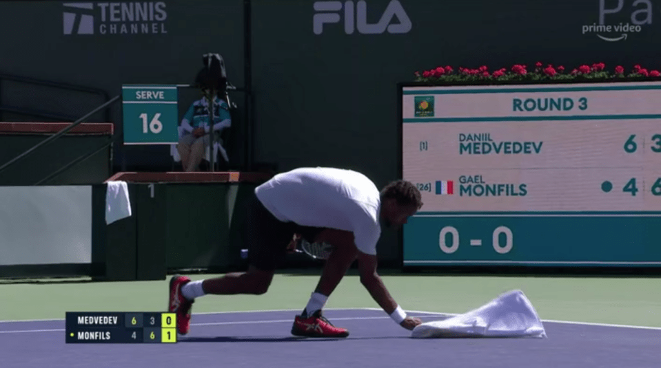 Gael Monfils had to grab a towel to swipe away the remaining debris