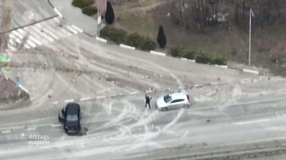 The man gets out of his car with his hands up