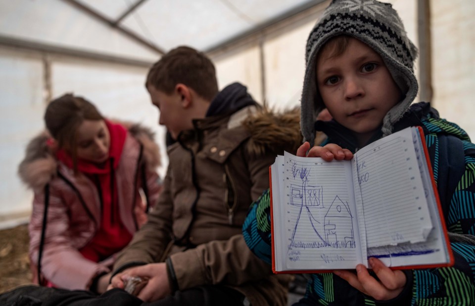 Young kids wait at a temporary refuge camp in Hungary after fleeing Ukraine