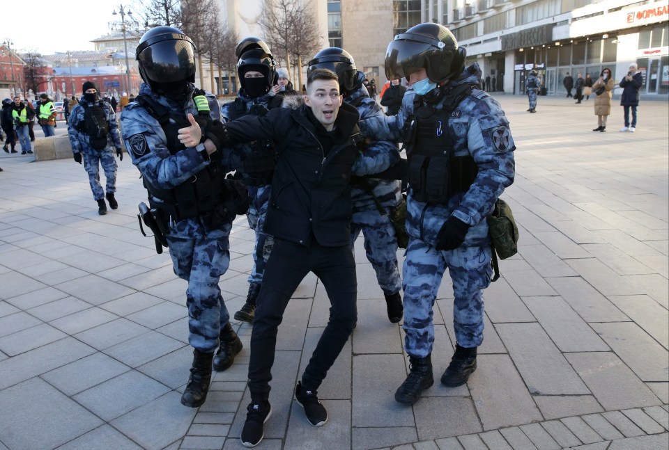 A protester in Moscow is taken away by riot police