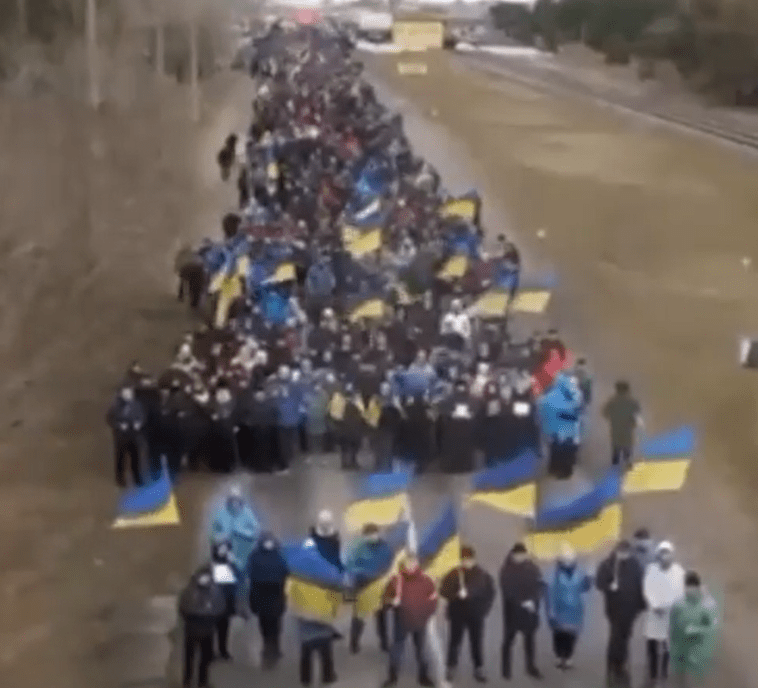 Many who were in the human barricade carried Ukrainian flags