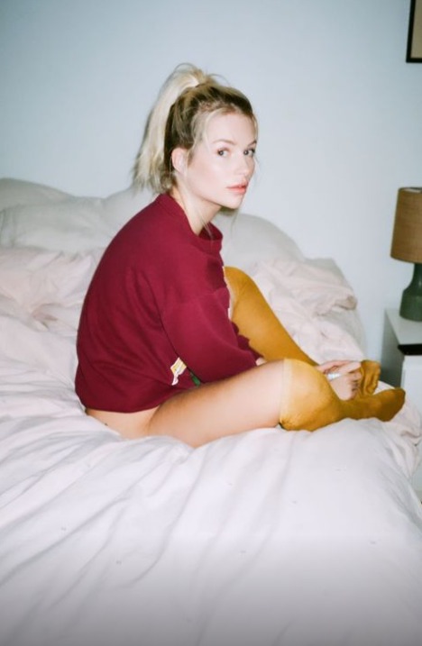 Lottie Moss posed in just her socks and a jumper at home