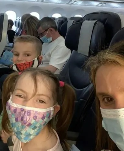 Sue shared videos of the family on the plane, on their way to the USA