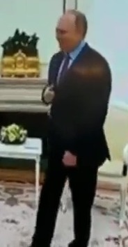 The Russian tyrant looks unsteady as he greets a visitor in a resurfaced clip