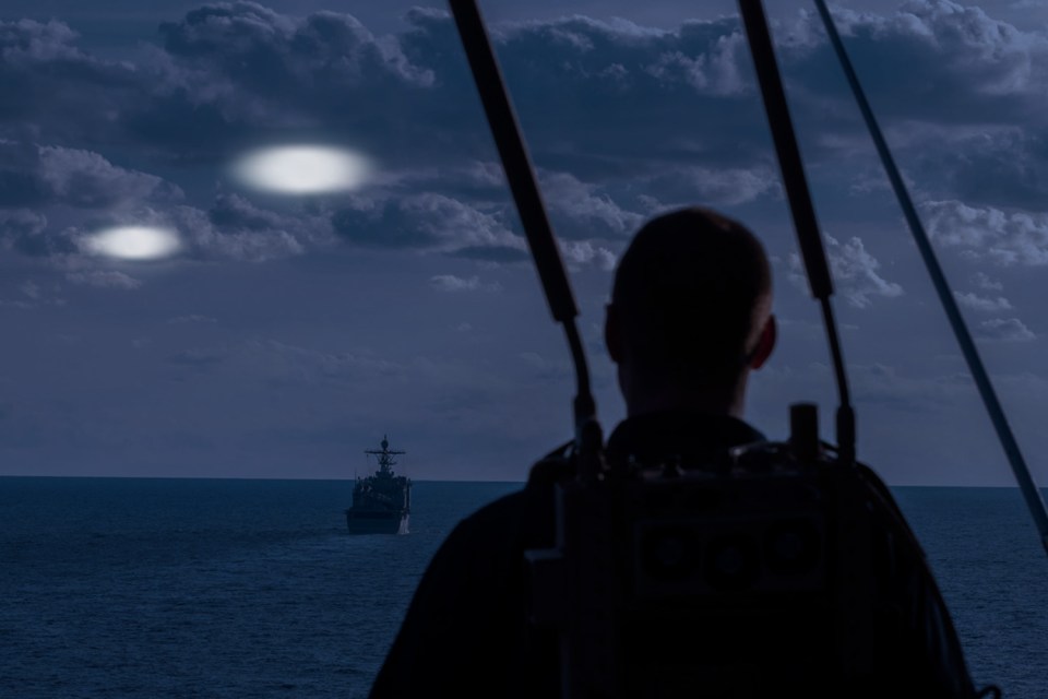 Mock up of two balls of light flying over the USS Kearsarge