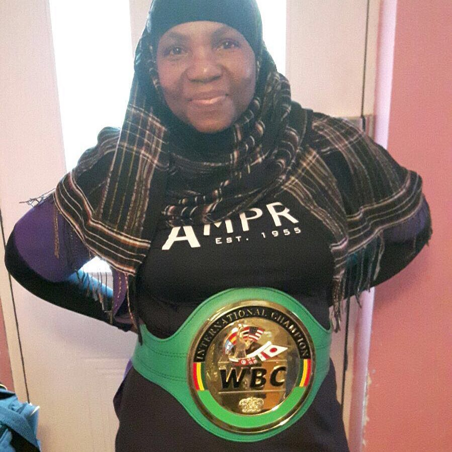 Dillian's mother Jerroleen poses with his WBC belt