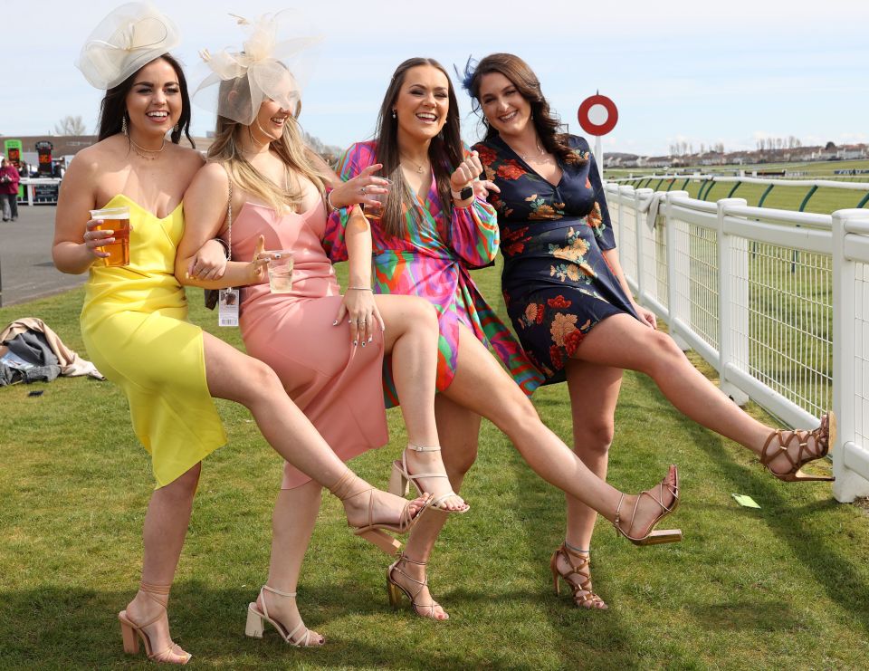 Racegoers pose for a photo during the Scottish Grand National at Ayr Racecourse