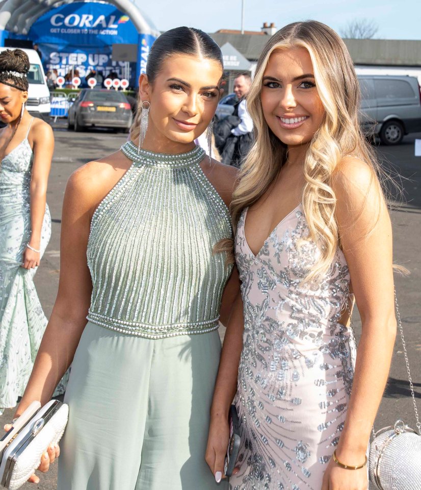 Two friends donning elegant gowns smiled for a picture