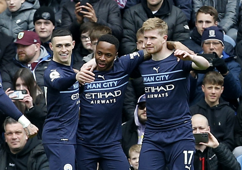 The Belgian celebrates with pals Raheem Sterling and Phil Foden