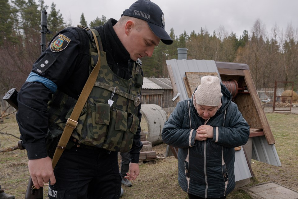 Hennadiy Merchynskyi’s widow looks down the well where Russians dumped his body