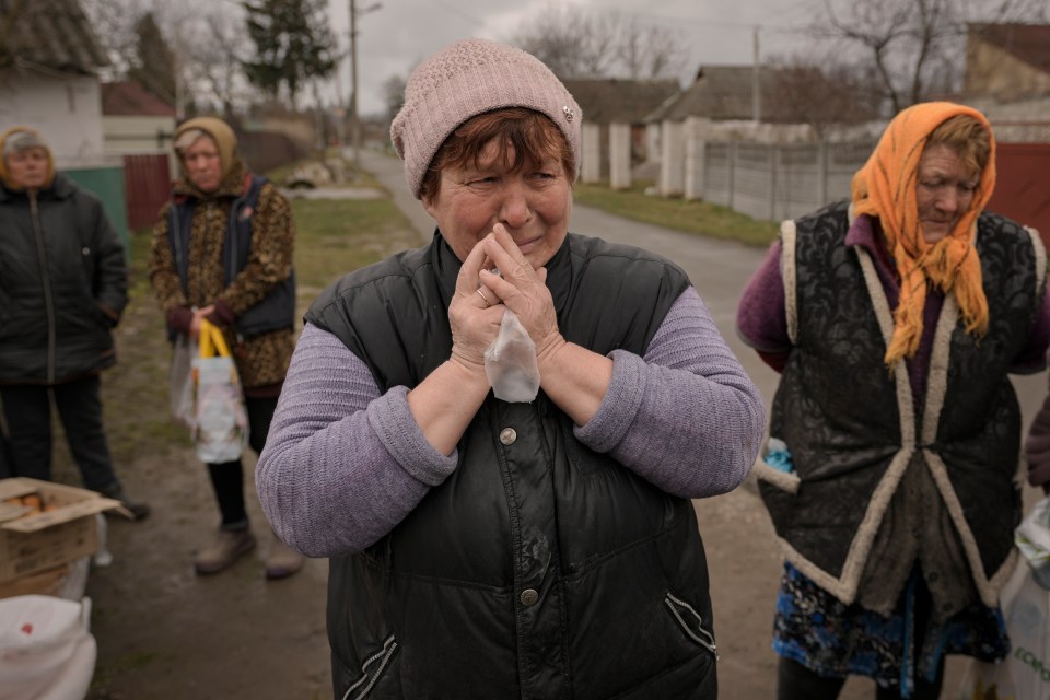 Grieving villagers after Russian soldiers retreated from Motyzhyn