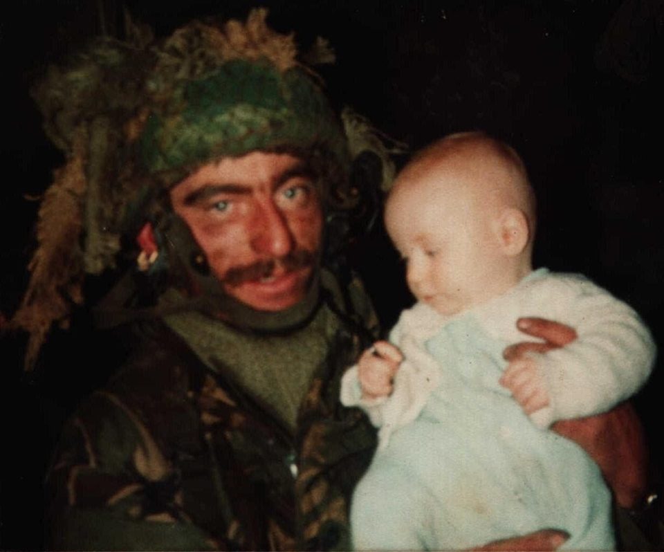 Paratrooper Jimmy Goodall with baby Matthew McMullen, the Falklands baby he helped to rescue from captivity