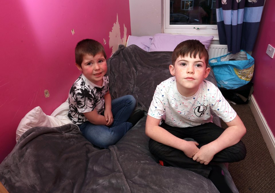 Kellan, 6, and Blake, 8, share a single bed