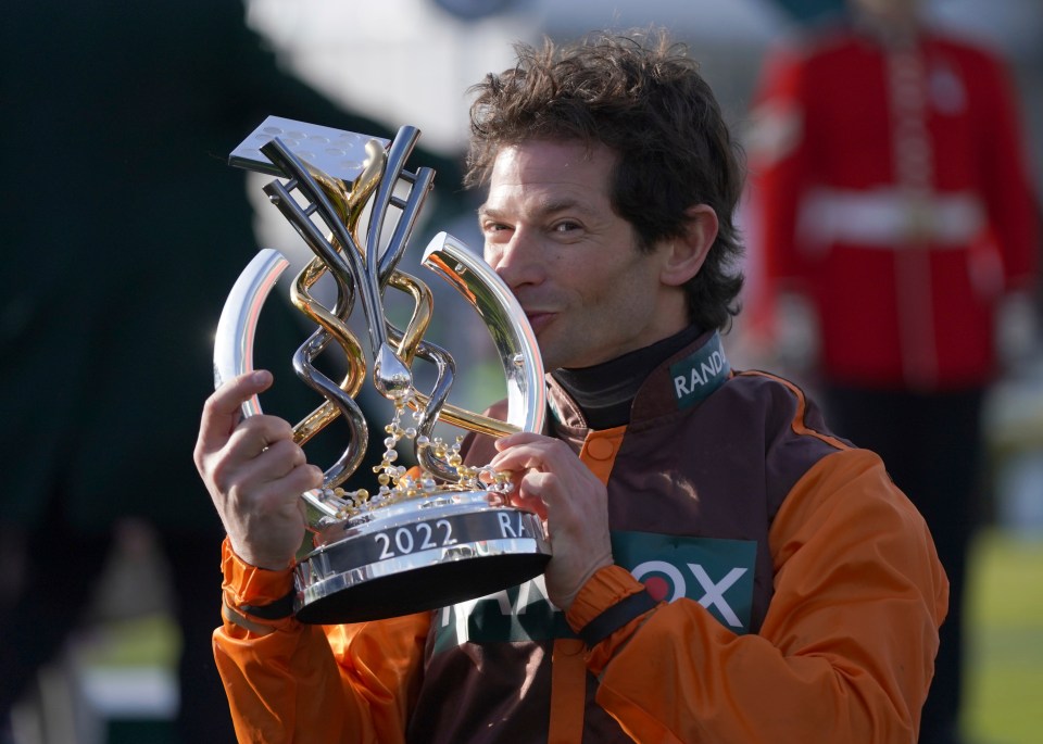 Waley-Cohen kisses the trophy after his amazing win at 50-1 odds