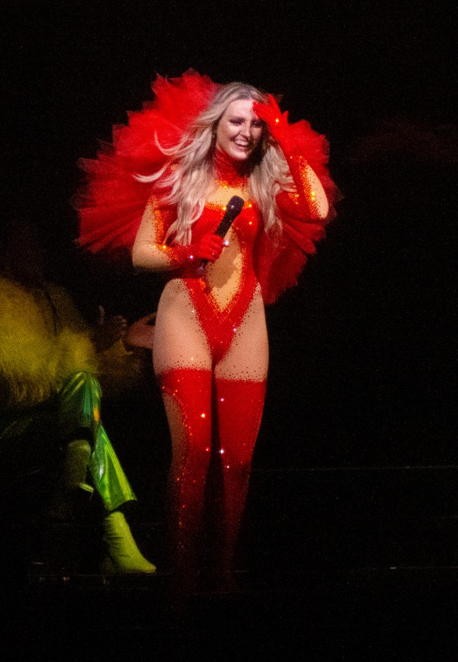 The girls took to the stage in Belfast for their long-delayed Confetti tour - pictured Perrie in plumes