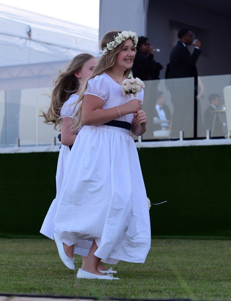 Harper, ten looked angelic with a posy in her hair as she danced with the other bridesmaids at the wedding