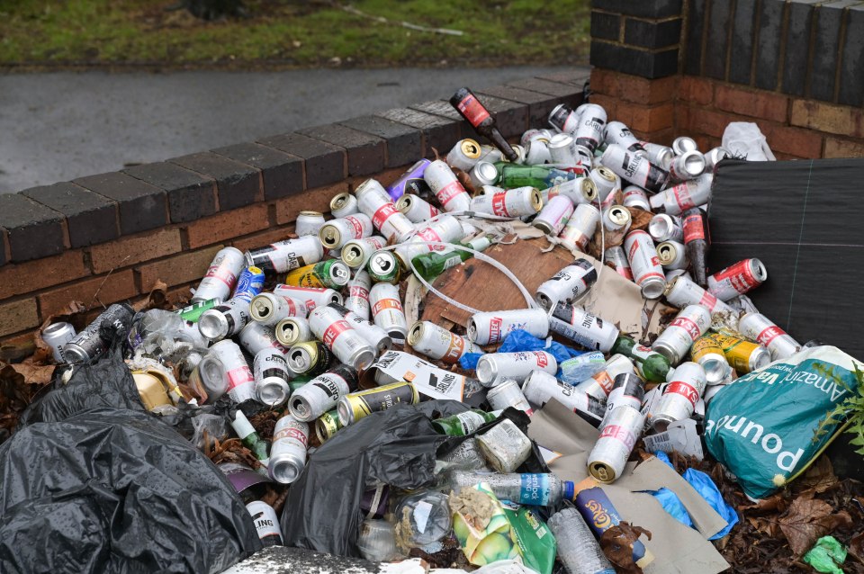 There are piles of rubbish littering areas near homes and shops