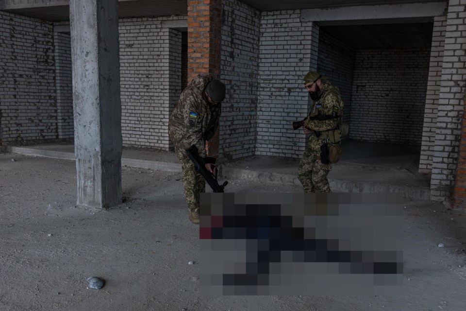 The man is believed to have been a volunteer fighter - and he was still wearing his helmet emblazoned with a pro-Ukrainian slogan