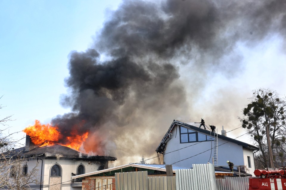 Fire fighters tackle a blaze after the Russains bombed a residential area of Kharkiv