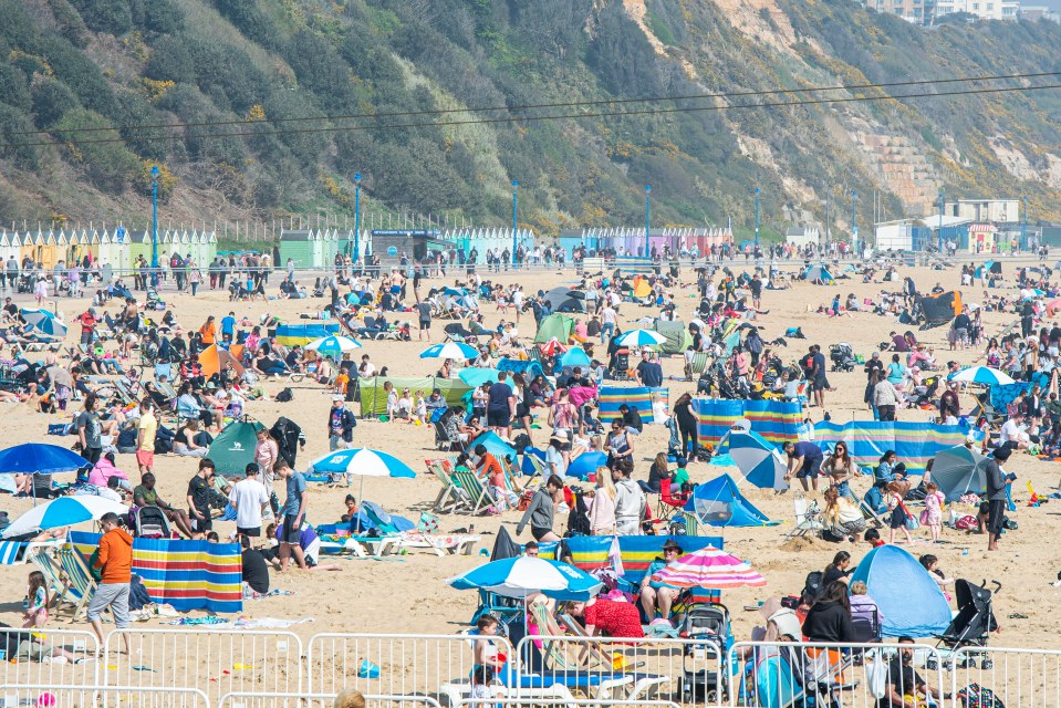 Families enjoy the bright sunshine on the beach