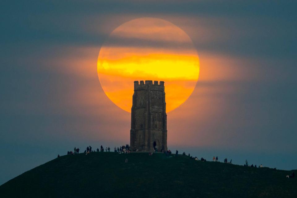 April's full moon, known as a Pink Moon, rose behind St Michael's Tower on Glastonbury Tor in Somerset