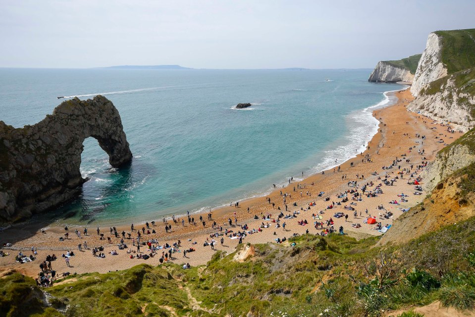 The beach is busy as holidaymakers flock to Durdle Door in Dorset