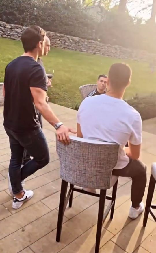 The couple are understood to have thrown a barbecue over the weekend before the births (Ronaldo is pictured facing man with white T-shirt)