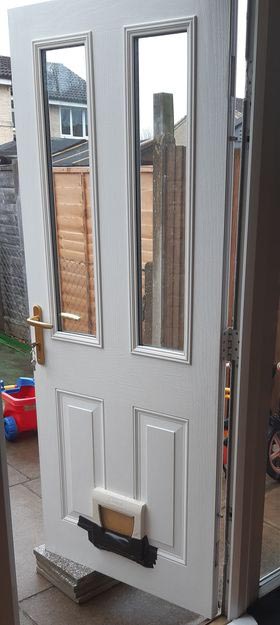 Miranda's back door currently has only one hinge and is supported by paving slabs