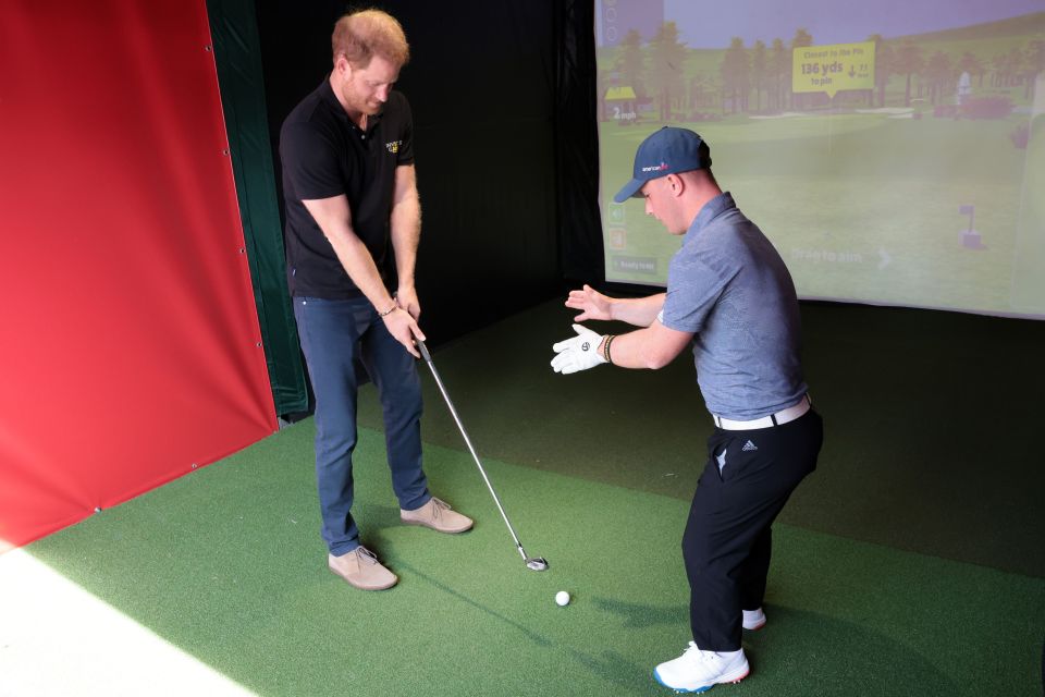 Prince Harry gets a golf lesson during day four of the Invictus Games yesterday