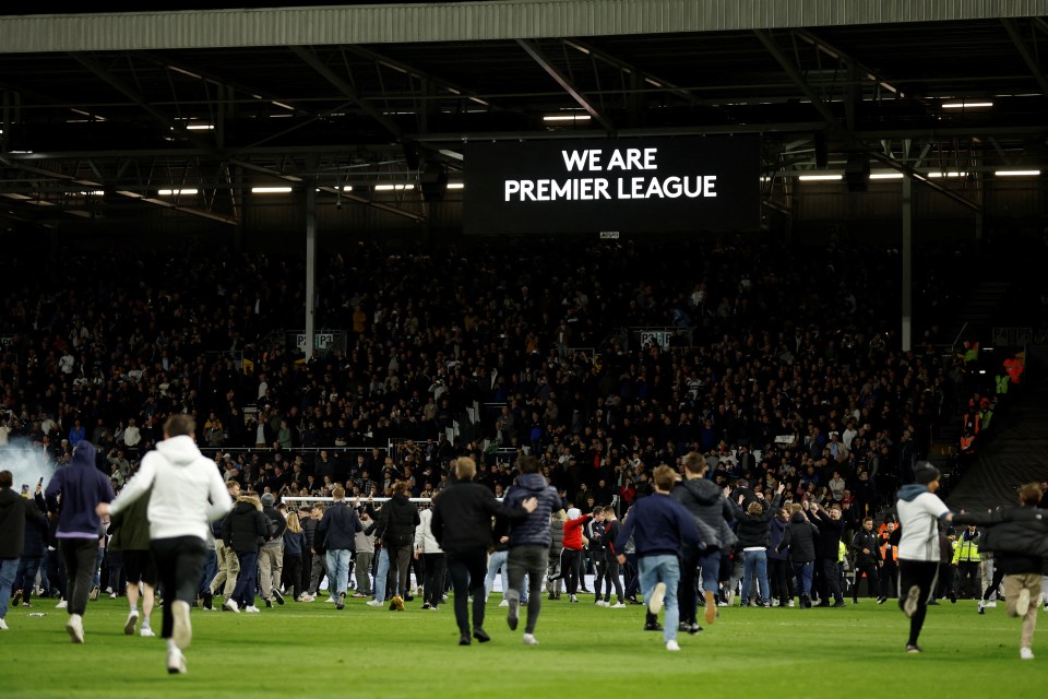 Hundreds of Fulham fans ran onto the pitch after their return to the Premier League was confirmed