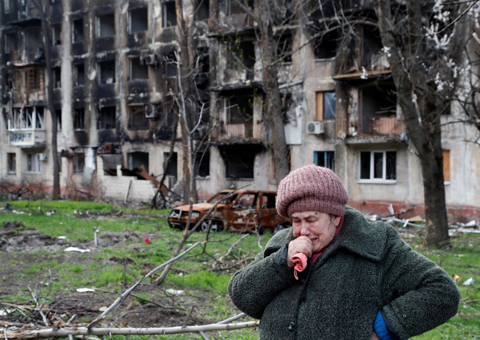 Tamara, 71, cries in front of an apartment building destroyed by Russian troops