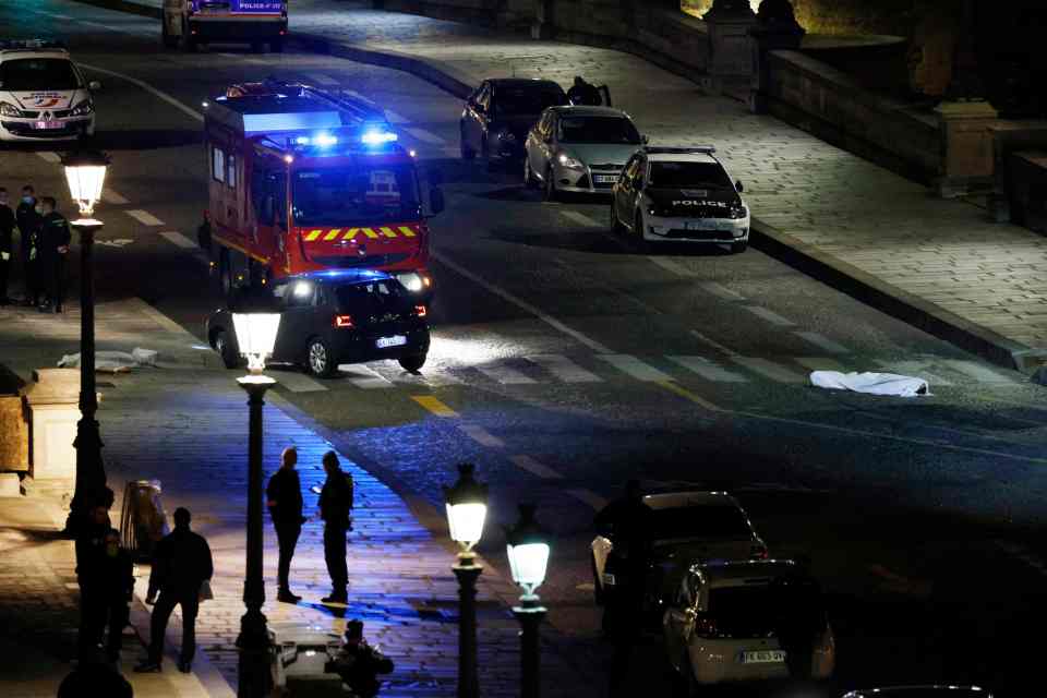 Police investigate the site of a shooting in Paris