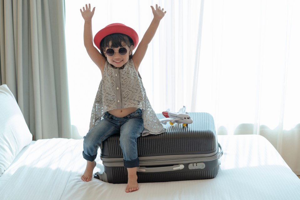 Happy Asian kid child girl playing with toy airplane. Travel, tourism and tourist concept.