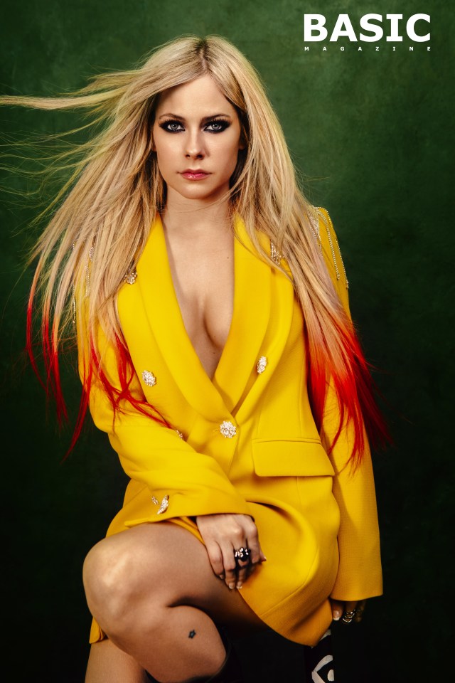 Avril dazzled in a bright- yellow jacket, lapels wide open at the front, then in an orange frock with platform boots