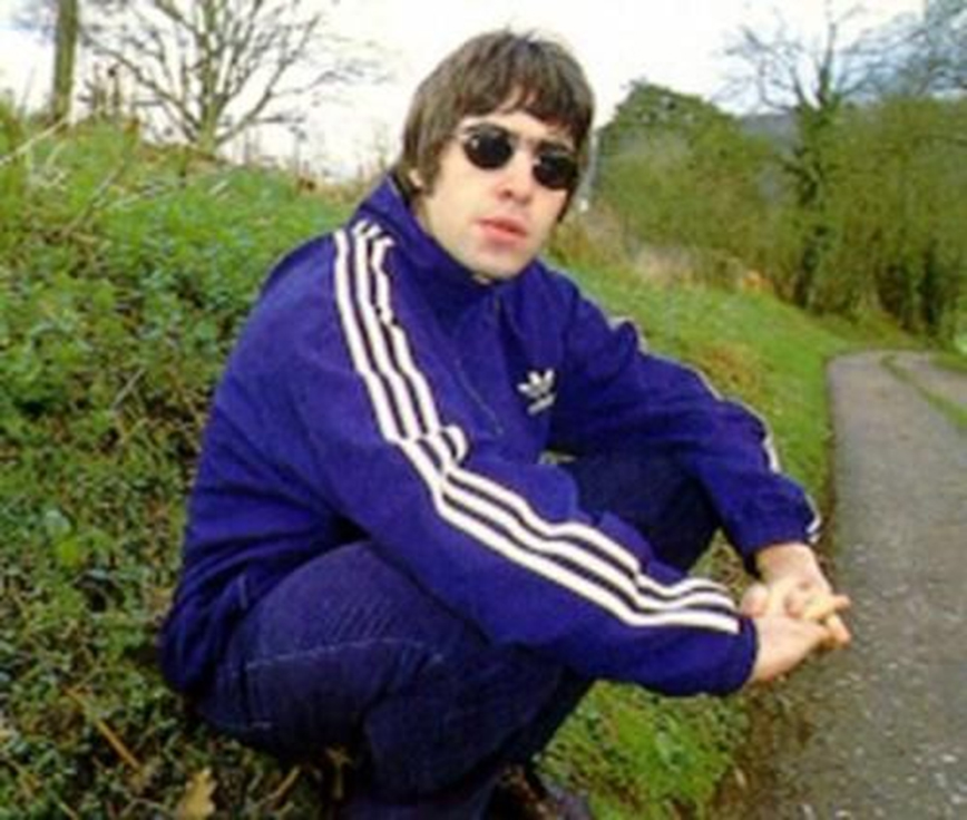 Gene was stealing his dad’s style with his mop hair and Adidas trackie top