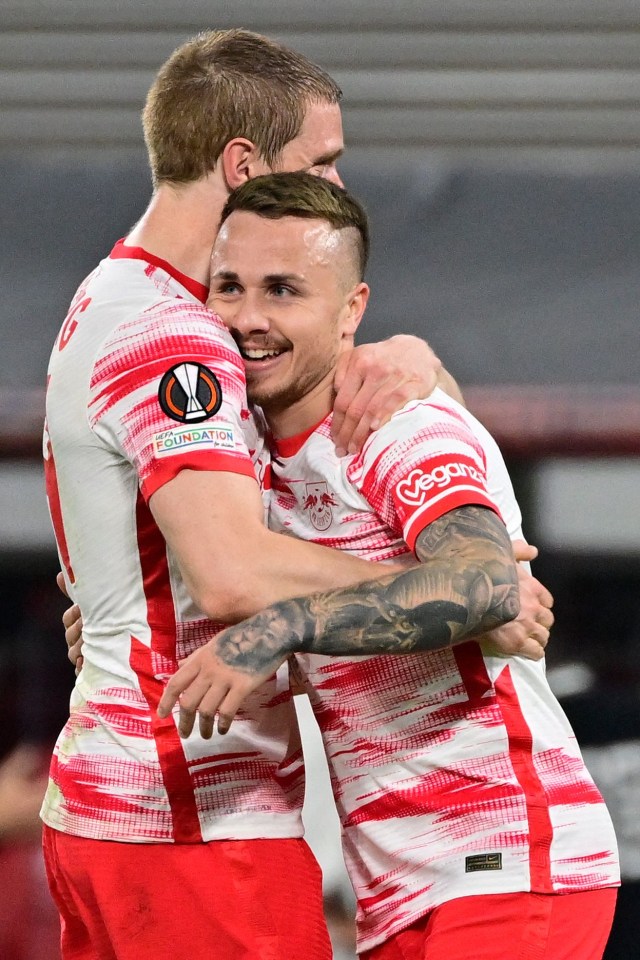 Marcel Halstenberg helps match-winning fellow defender Angelino celebrate netting the only goal at Ibrox