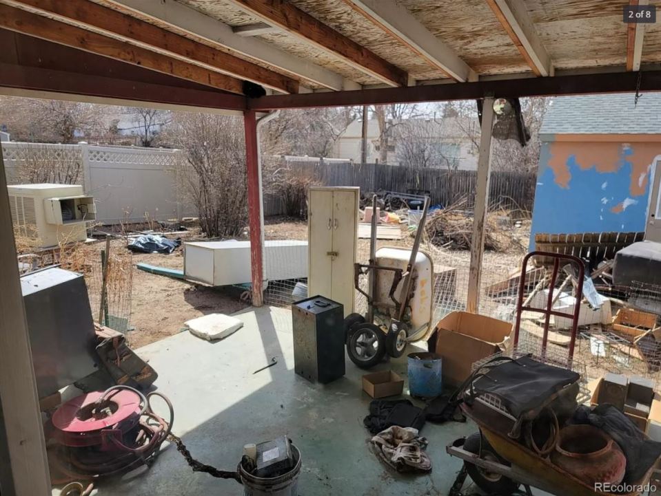 Pictures show it filled with piles of junk - but it has a 'great garage'