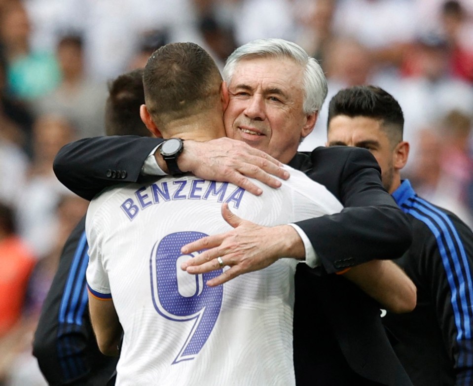 Carlo Ancelotti embraces Karim Benzema after winning the La Liga title