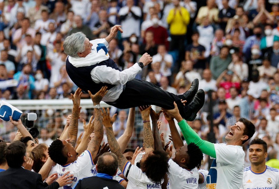 Real Madrid manager Carlo Ancelotti is thrown in the air by his players