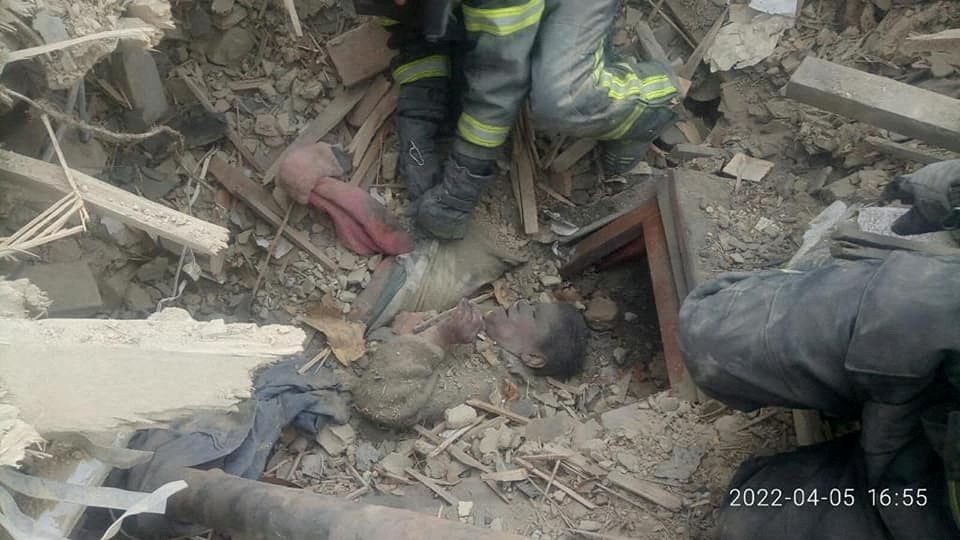 Rescuers remove a woman from debris after a Russian strike on the town of Rubizhne in Luhansk