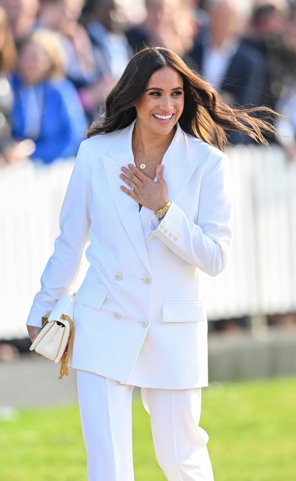 Meghan was clad all in white, with an oversized £2,100 Valentino blazer, matching £1,100 flared trousers, plus a pair of £810 white Aquazzura heels