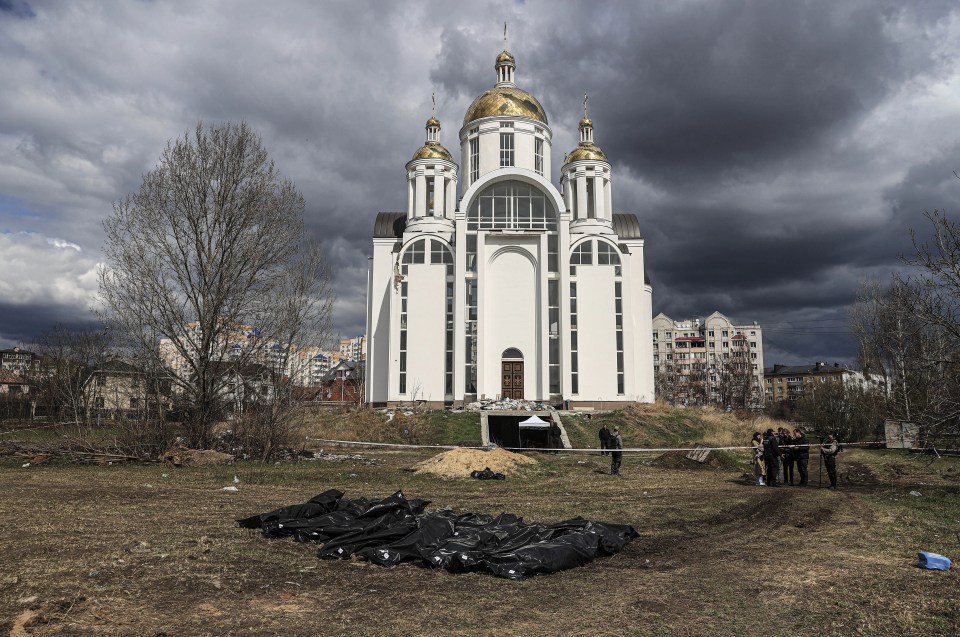 Officials exhume the bodies of civilians who died during the Russian attacks