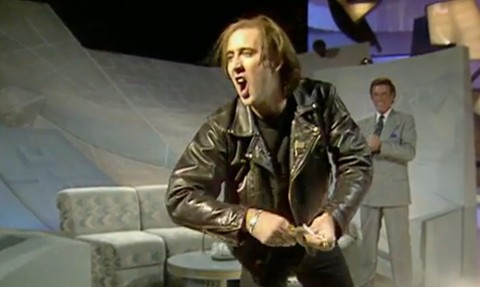 The American film star performed a somersault and high kicks in a leather jacket then flung cash at Terry Wogan’s audience in 1990