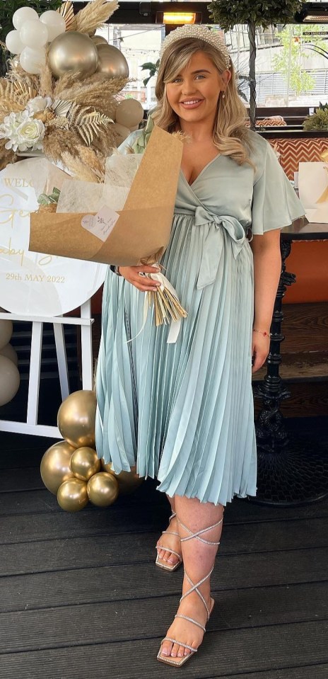 Georgia with a bunch of flowers at her baby shower