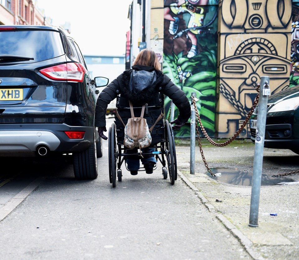 Wheelchair users struggle to pass by when cars park on the pavement